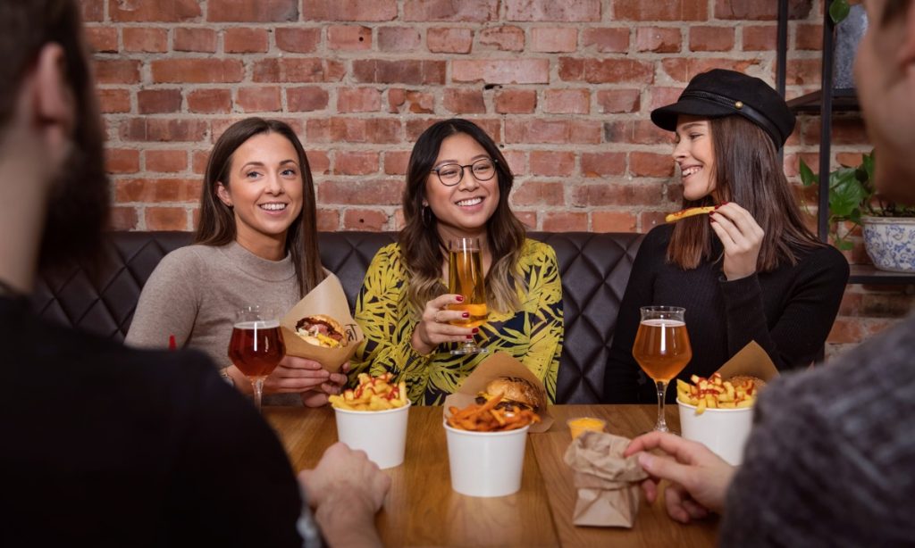 Three girls in a hamburger restaraunt